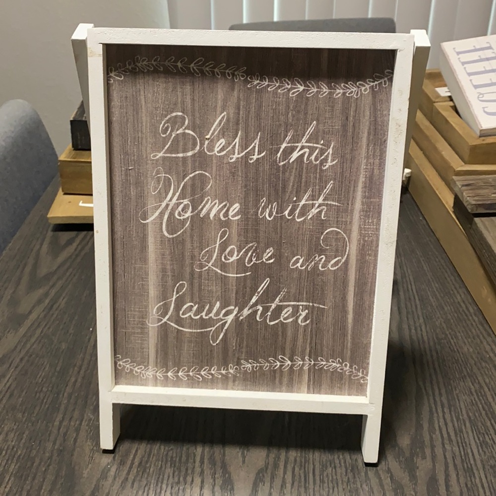 “Bless this home with love and laughter” sign